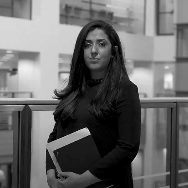 Nabeela Rasul clutches a diary planner as she stares stoically at the camera